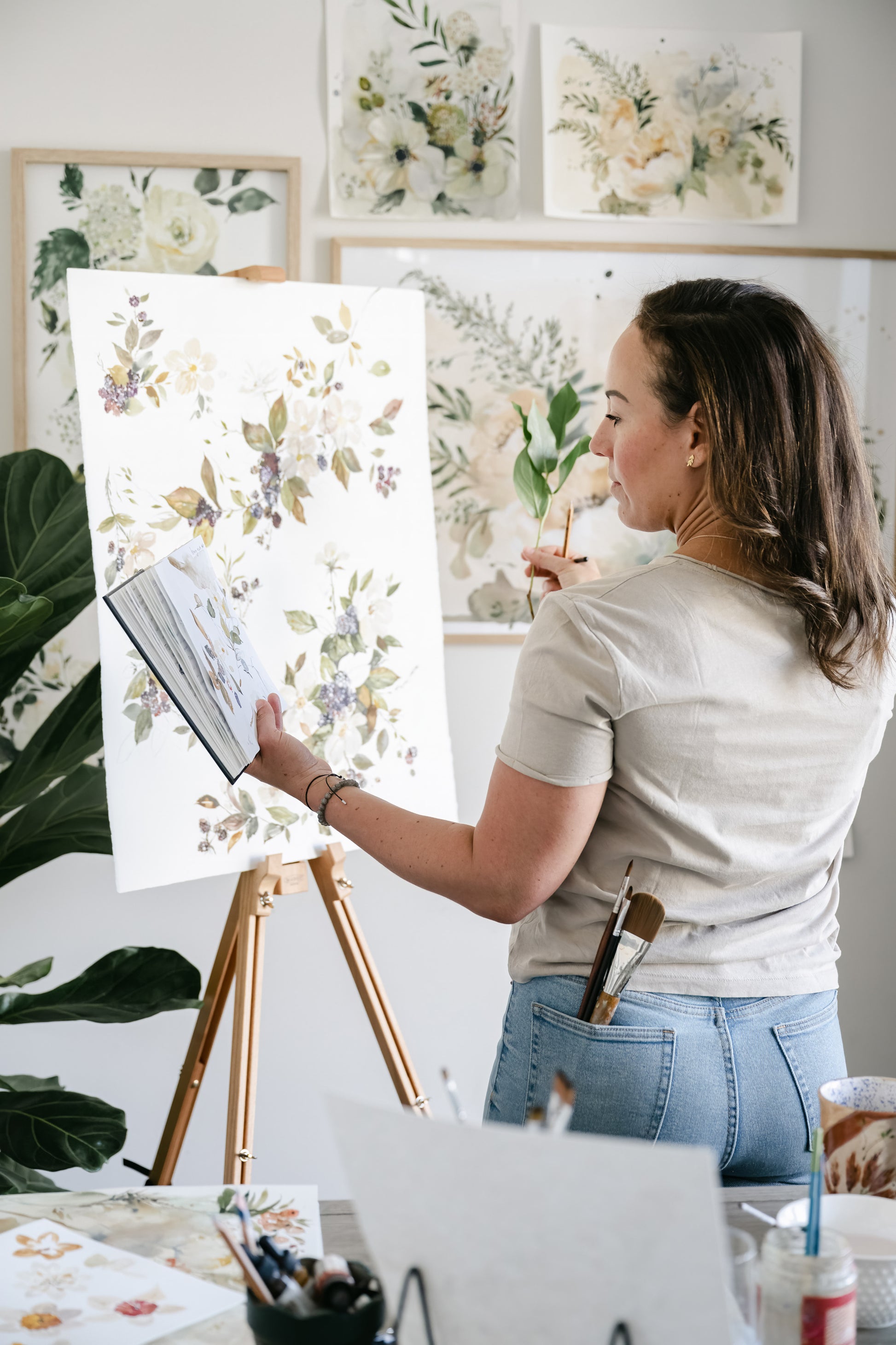 Artist Tonya Cruz painting Blackberry Blossoms in studio